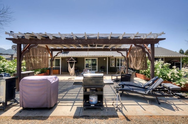 view of patio / terrace with an outdoor fire pit and a pergola