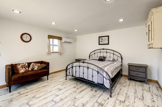 bedroom with baseboards, recessed lighting, light wood-type flooring, and a wall mounted AC