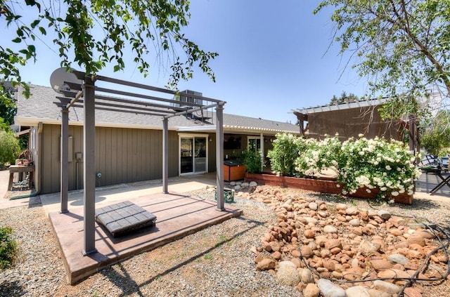 rear view of house featuring central air condition unit, a patio area, and a pergola