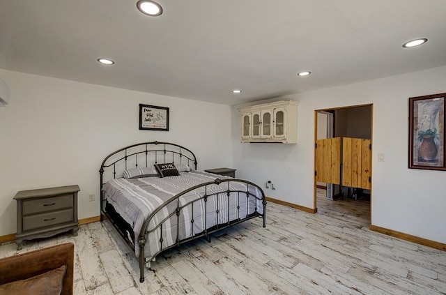 bedroom featuring light wood finished floors, baseboards, and recessed lighting