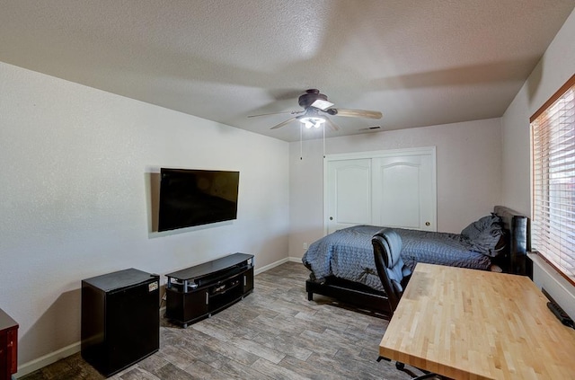 20794 E Weldon Ave, Sanger, CA 93657 - bedroom with wood finished floors, a closet, ceiling fan, and a textured ceiling