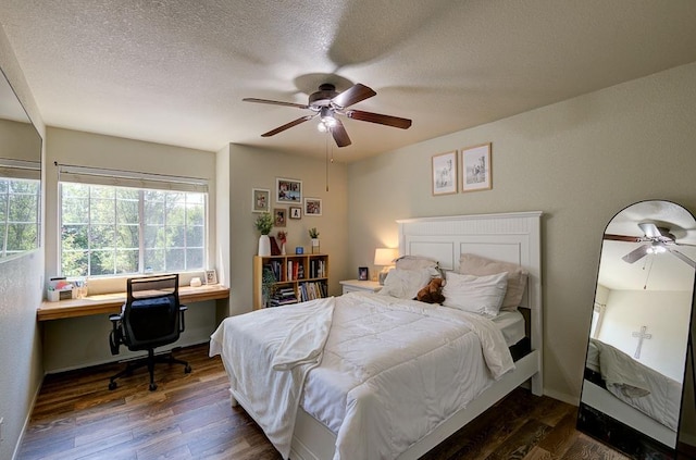 bedroom with ceiling fan, a textured ceiling, and wood finished floors
