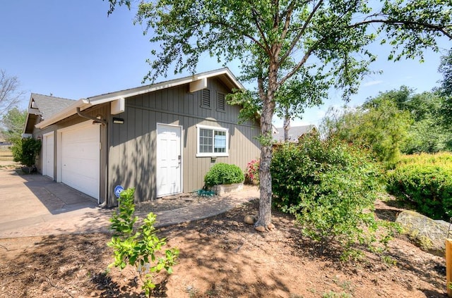 view of property exterior featuring driveway and an attached garage