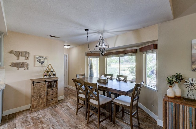 20794 E Weldon Ave, Sanger, CA 93657 - dining area with a textured ceiling, a chandelier, and wood finished floors