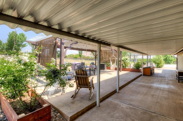 view of patio featuring outdoor dining space and fence