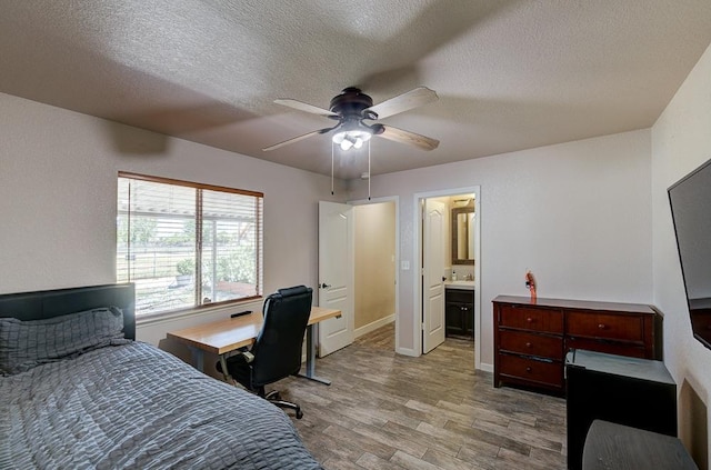 20794 E Weldon Ave, Sanger, CA 93657 - bedroom featuring wood finished floors, a textured ceiling, a desk, ceiling fan, and ensuite bathroom