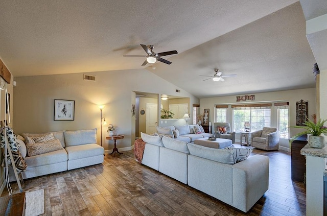 living room with lofted ceiling, visible vents, ceiling fan, dark wood-style floors, and baseboards