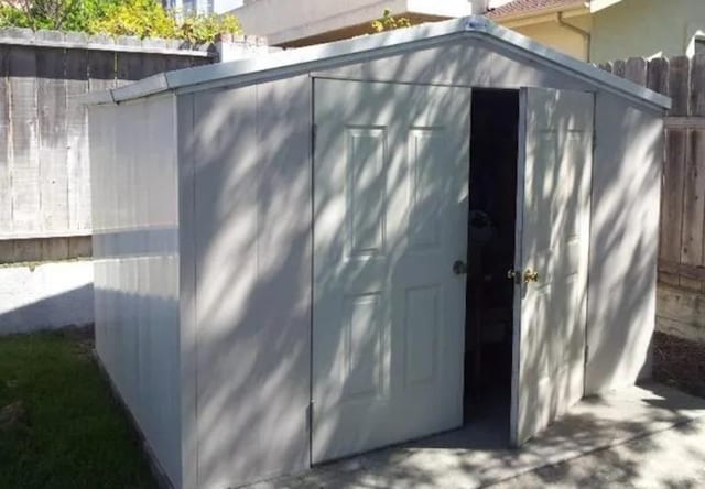view of shed with fence