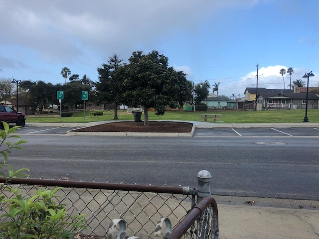 view of road featuring street lighting and curbs