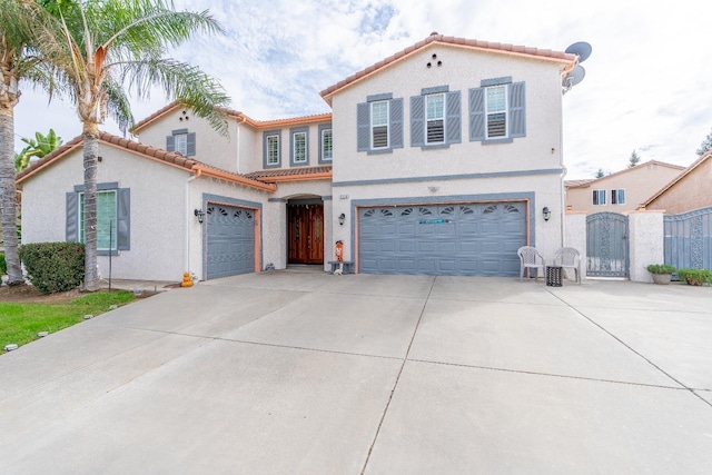 2776 Keats Ave, Clovis, CA 93611 - mediterranean / spanish home with a gate, a garage, a tiled roof, stucco siding, and concrete driveway
