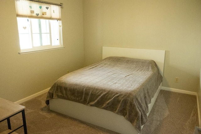 carpeted bedroom featuring baseboards