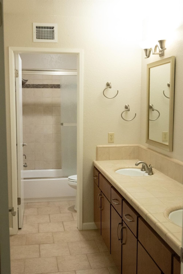 full bath featuring shower / bathtub combination, toilet, visible vents, a sink, and double vanity