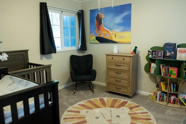bedroom with baseboards, a nursery area, and light colored carpet