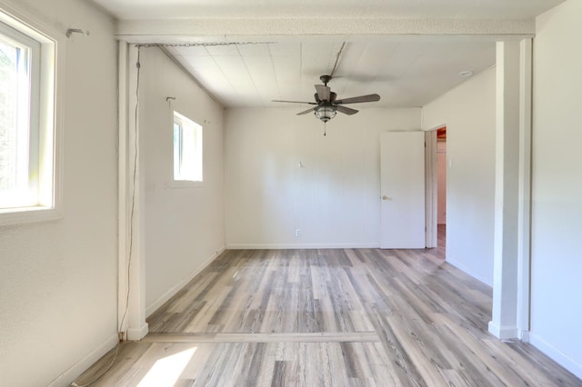 spare room with light wood-type flooring, baseboards, and ceiling fan