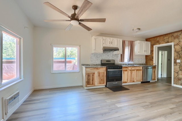 kitchen featuring under cabinet range hood, stainless steel appliances, and plenty of natural light