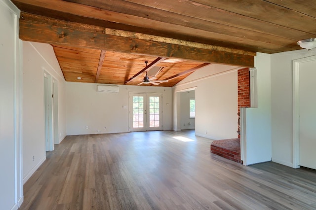 empty room featuring baseboards, french doors, vaulted ceiling with beams, and wood finished floors