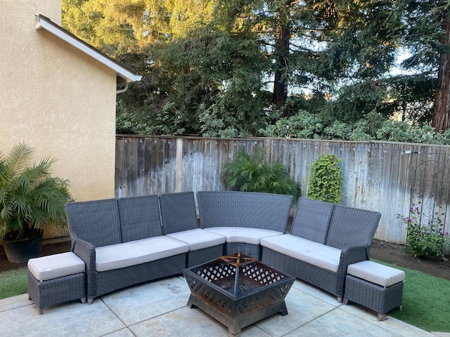 view of patio / terrace featuring an outdoor living space with a fire pit and a fenced backyard