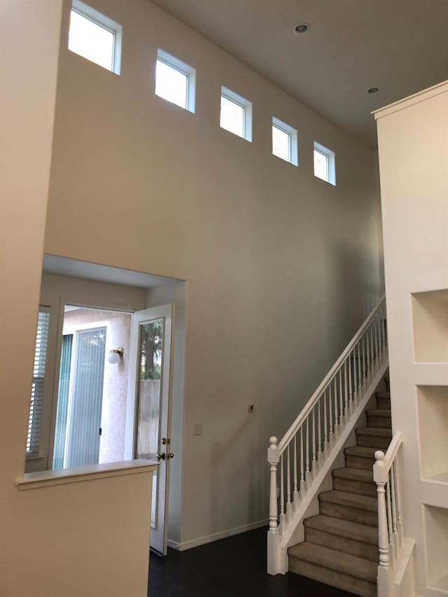 foyer with stairway and a high ceiling