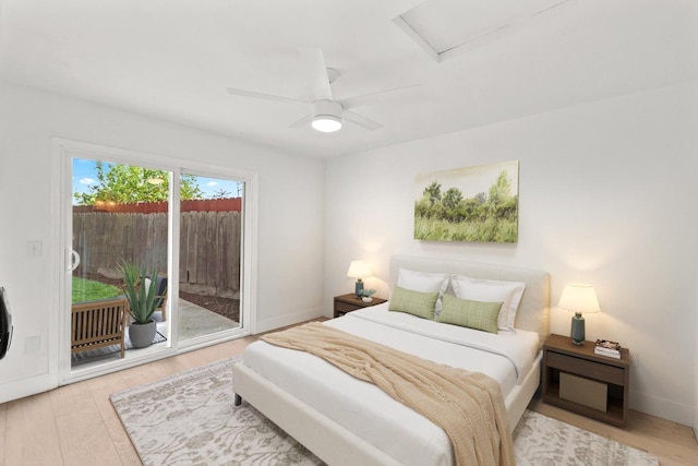 bedroom with wood finished floors, attic access, baseboards, ceiling fan, and access to outside