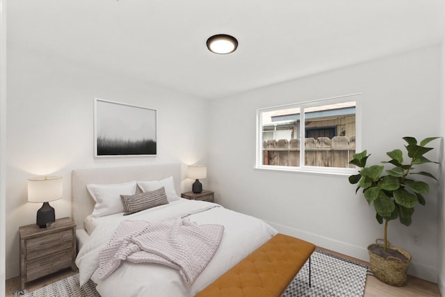 bedroom with baseboards and wood finished floors