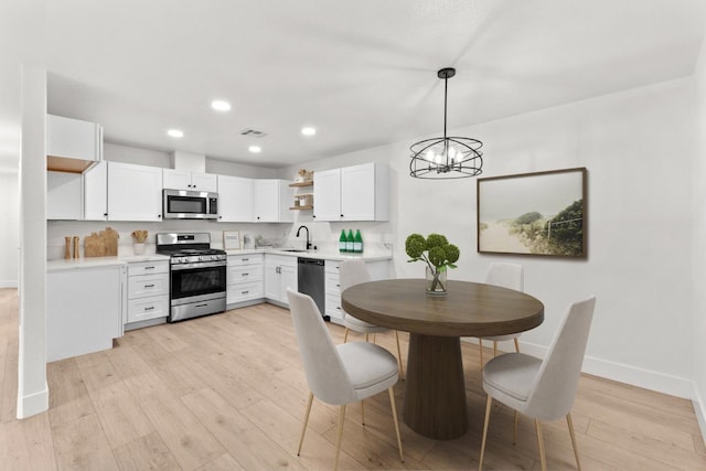 dining room featuring visible vents, recessed lighting, light wood finished floors, a chandelier, and baseboards