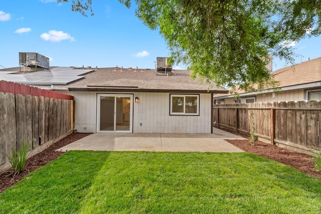 rear view of house with a patio area, central AC, and a lawn