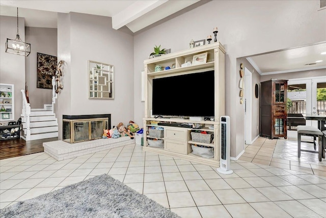 living room with light tile patterned floors, baseboards, an inviting chandelier, a fireplace, and vaulted ceiling with beams