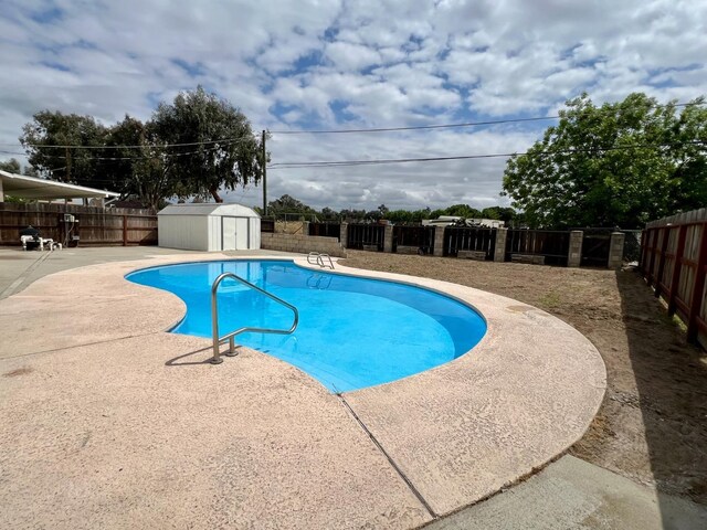 3330 Virginia St, Atwater, CA 95301 - view of pool with a fenced backyard, a storage shed, a patio, and a fenced in pool