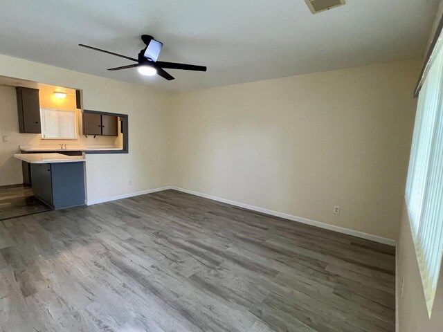 3330 Virginia St, Atwater, CA 95301 - unfurnished living room with dark wood-style flooring, baseboards, ceiling fan, and visible vents