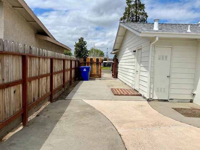 3330 Virginia St, Atwater, CA 95301 - view of property exterior featuring a shingled roof, a patio, and fence