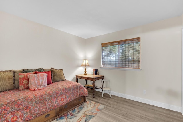 bedroom featuring baseboards and wood finished floors
