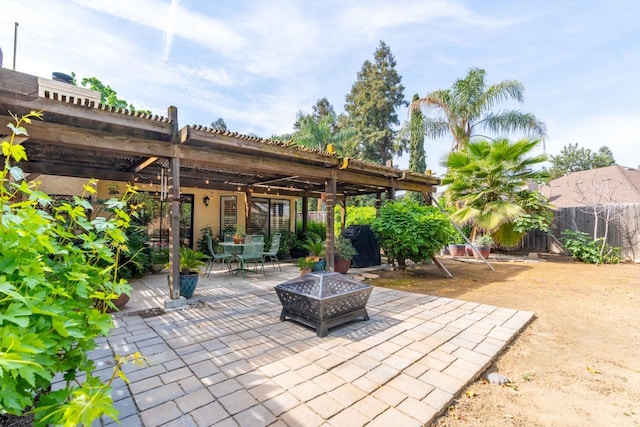 view of patio featuring a fire pit, a pergola, fence, and outdoor dining space