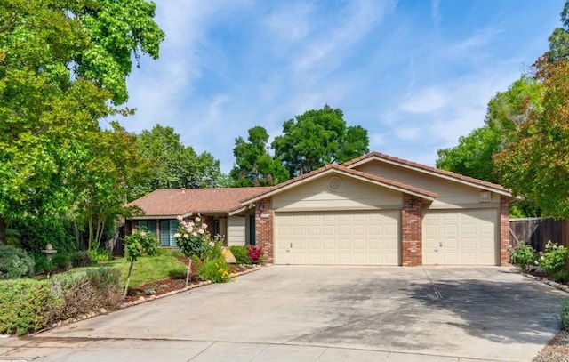 ranch-style home with concrete driveway, brick siding, and an attached garage