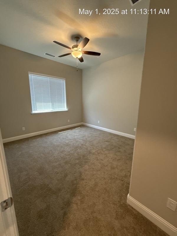 1765 N Whitmore, Clovis, CA 93619 - empty room featuring ceiling fan, dark colored carpet, baseboards, and visible vents