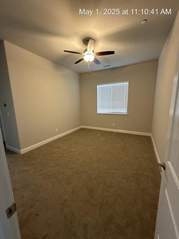 1765 N Whitmore, Clovis, CA 93619 - spare room featuring ceiling fan, dark colored carpet, baseboards, and visible vents