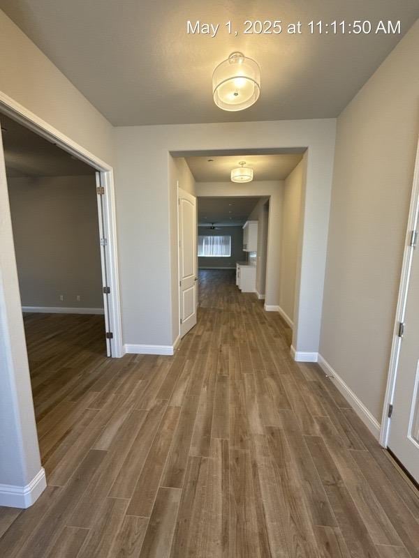 1765 N Whitmore, Clovis, CA 93619 - corridor with baseboards and wood finished floors