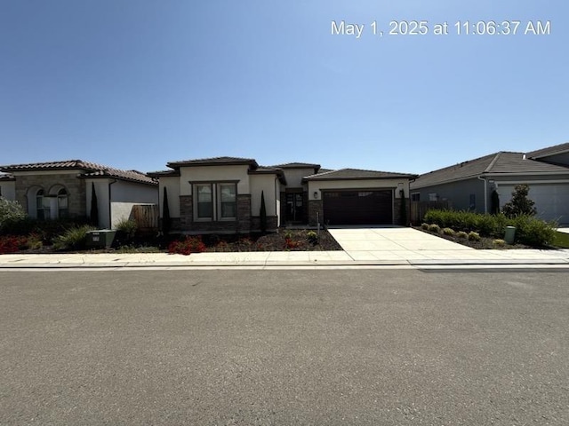 1765 N Whitmore, Clovis, CA 93619 - prairie-style home featuring an attached garage, stucco siding, driveway, and stone siding