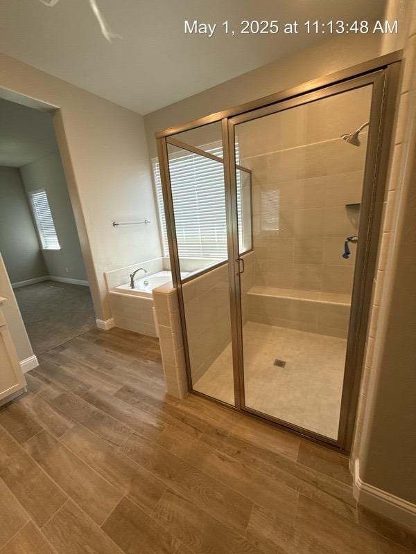 1765 N Whitmore, Clovis, CA 93619 - bathroom with a shower stall, baseboards, a bath, and wood finished floors