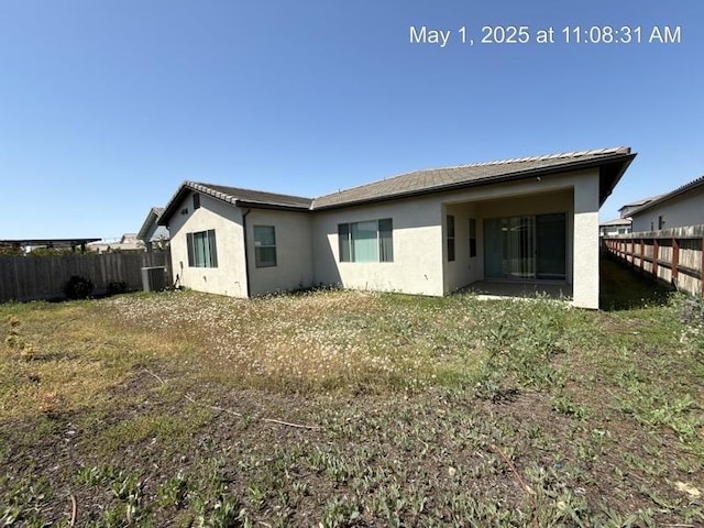 1765 N Whitmore, Clovis, CA 93619 - back of property with a fenced backyard, stucco siding, and cooling unit