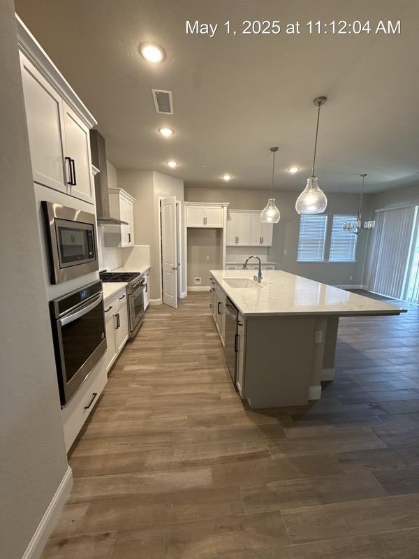 1765 N Whitmore, Clovis, CA 93619 - kitchen with a sink, visible vents, baseboards, appliances with stainless steel finishes, and recessed lighting
