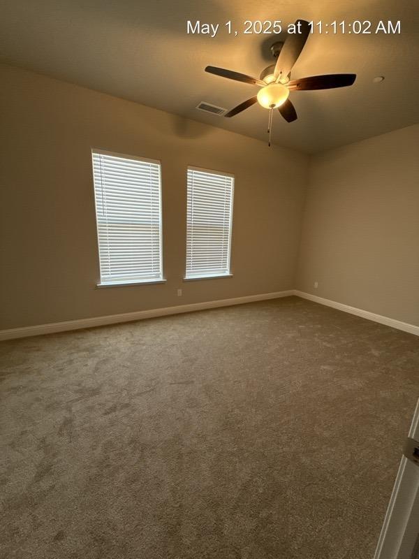1765 N Whitmore, Clovis, CA 93619 - carpeted empty room featuring visible vents, baseboards, and a ceiling fan