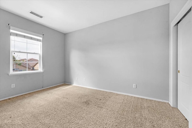 unfurnished bedroom featuring a closet, visible vents, baseboards, and carpet