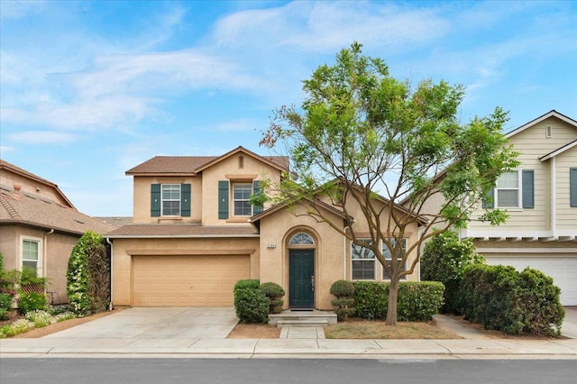 view of front of house with concrete driveway, stucco siding, and a garage
