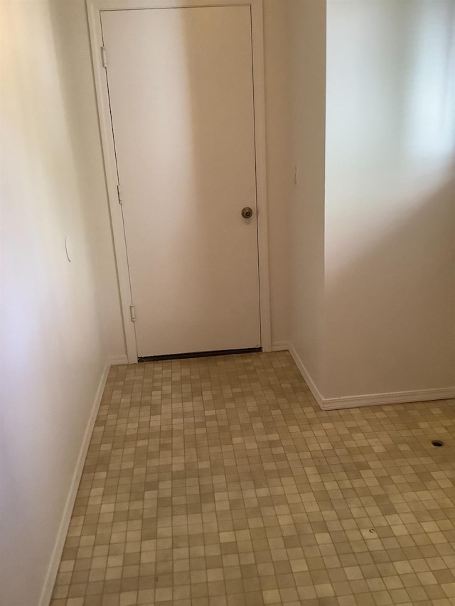 hallway featuring baseboards