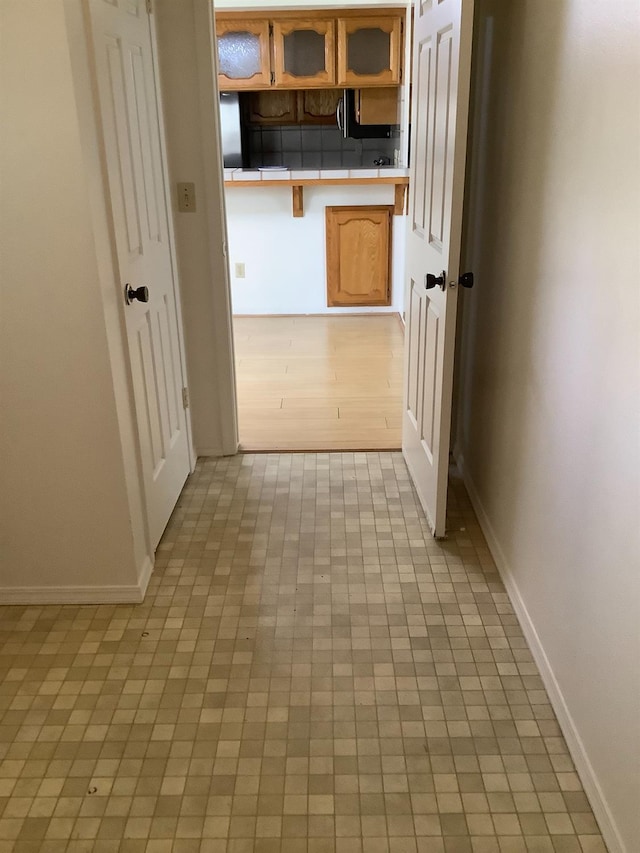 hall featuring baseboards