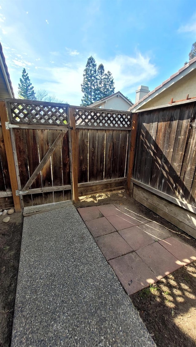 view of patio featuring a gate and fence