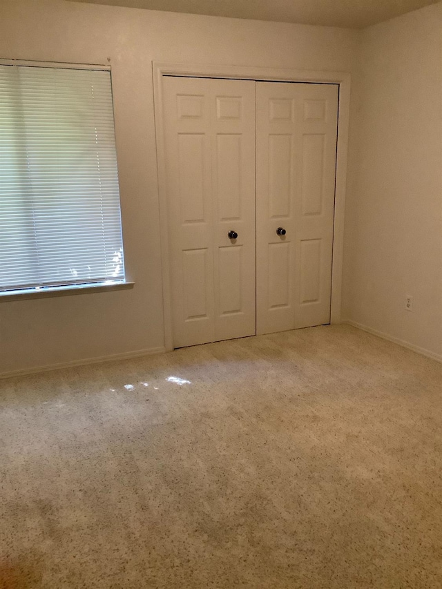 unfurnished bedroom with baseboards and carpet floors