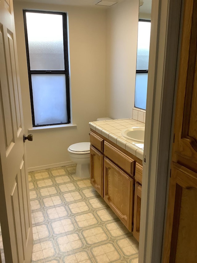 bathroom featuring tile patterned floors, toilet, and vanity