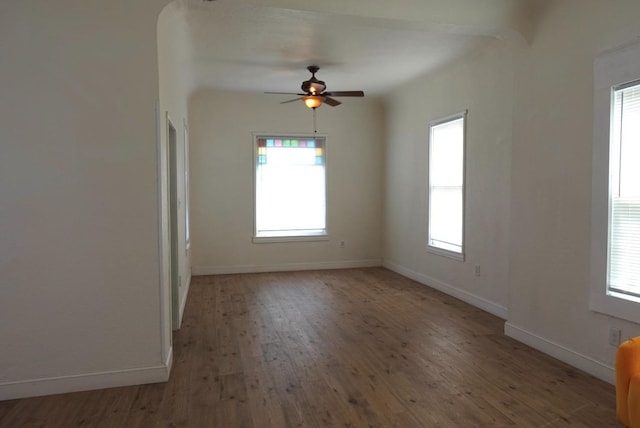 220 S K, Madera, CA 93637 - empty room featuring baseboards, a ceiling fan, a healthy amount of sunlight, and wood finished floors