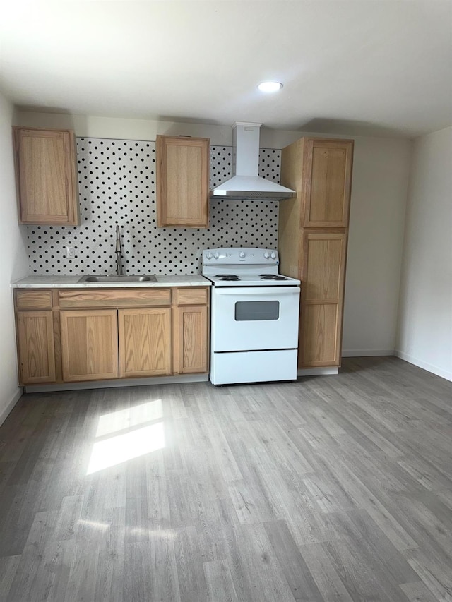 220 S K, Madera, CA 93637 - kitchen with baseboards, light wood finished floors, a sink, white range with electric cooktop, and wall chimney range hood